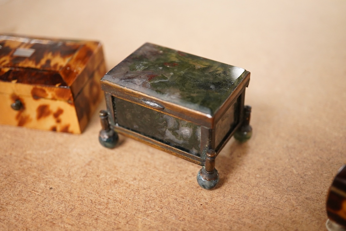 A 19th century miniature brass and agate trinket box and two early 19th century tortoiseshell needle boxes, largest 5.5cm wide x 2.5cm high
